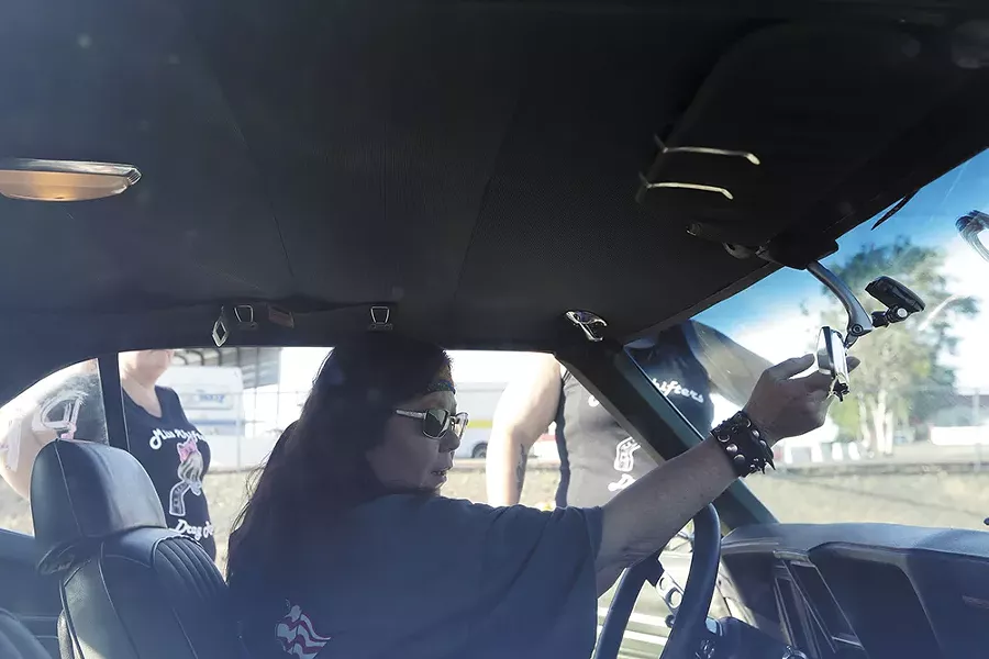 Annette Callesto adjusts the mirror in her 1969 Chevrolet Camaro. - YOUNG KWAK