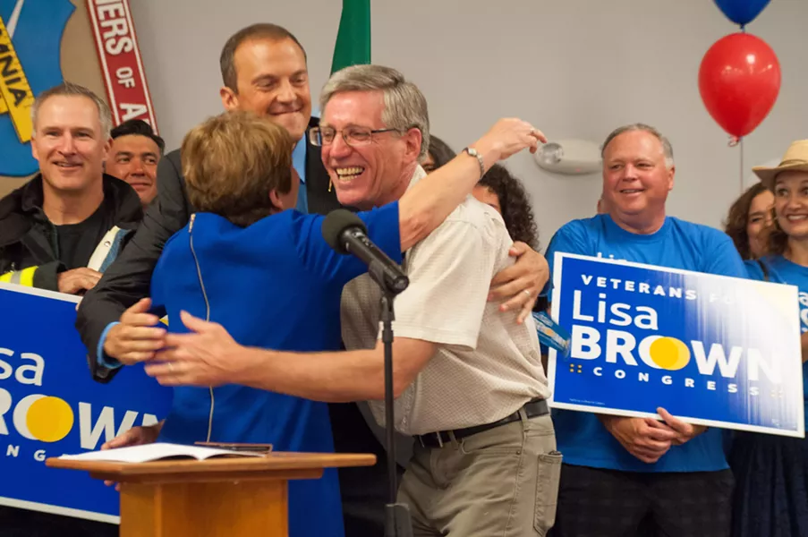 Lisa Brown shares a hug with Washington state Reps. Timm Ormsby and Marcus Recelli. - DANIEL WALTERS PHOTO