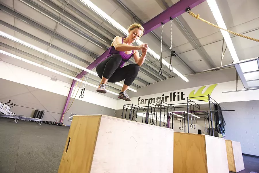 Farm Girl Fit co-owner Jenni Niemann demonstrates a box jump. - YOUNG KWAK