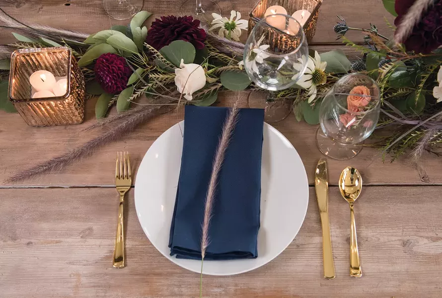 Signer employs basic tableware to make sure flowers get all the attention on this rustic table, which was crafted from salvaged planks by the homeowners Justin and Tarah Gray. - DON HAMILTON PHOTO