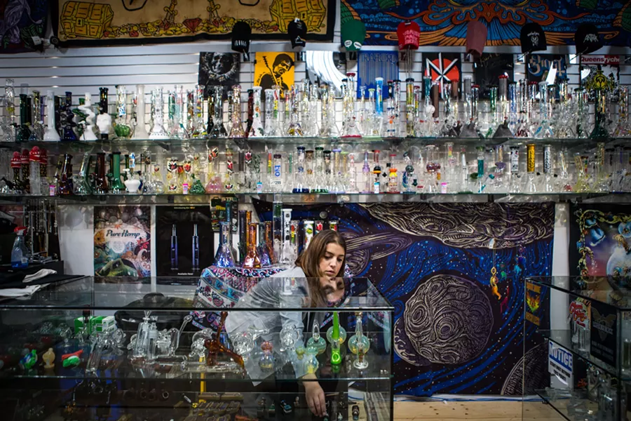 Lacey Macmurchy, an employee at BBFs head shop, arranges glassware in a display, in Toronto, Oct. 12, 2018. Canada on Oct. 17 became the first major world economy to legalize recreational marijuana use, beginning a national experiment that will alter the country’s social, cultural and economic fabric, and present the nation with its biggest public policy challenge in decades. - CHRIS DONOVAN/THE NEW YORK TIMES