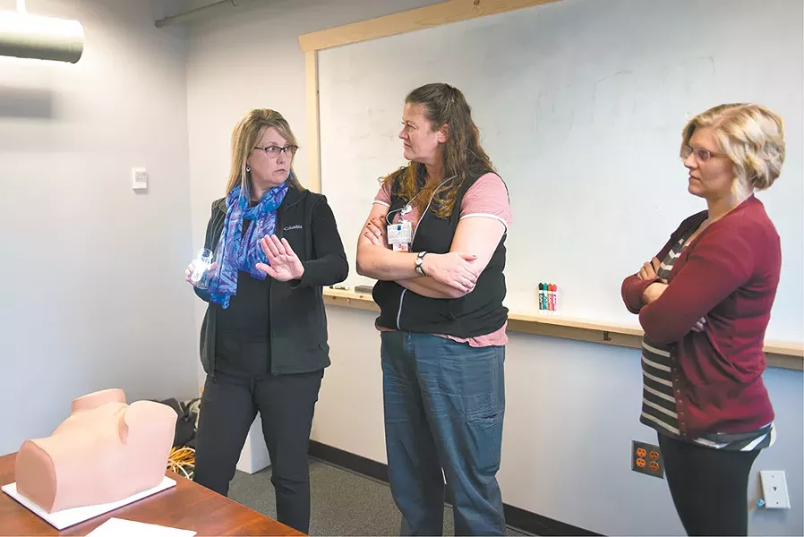Kelly Anderson (left) trains Georgia Davenport (center) and Josilyn Twardoski how to do pelvic exams. - SAMANTHA WOHLFEIL