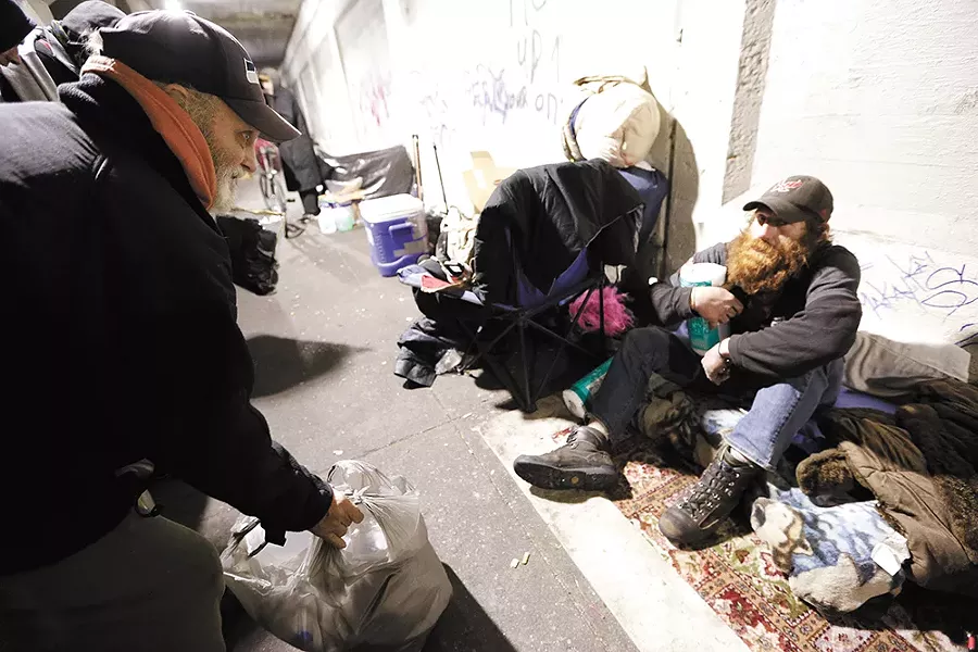 James Welch talks to John, who says he has been homeless for the past five of six months. - YOUNG KWAK