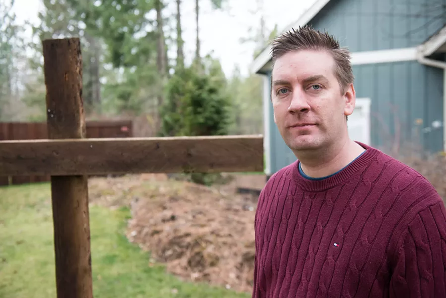 Jeremy Morris stands in front of a cross erected in front of his Hayden home. - DANIEL WALTERS PHOTO