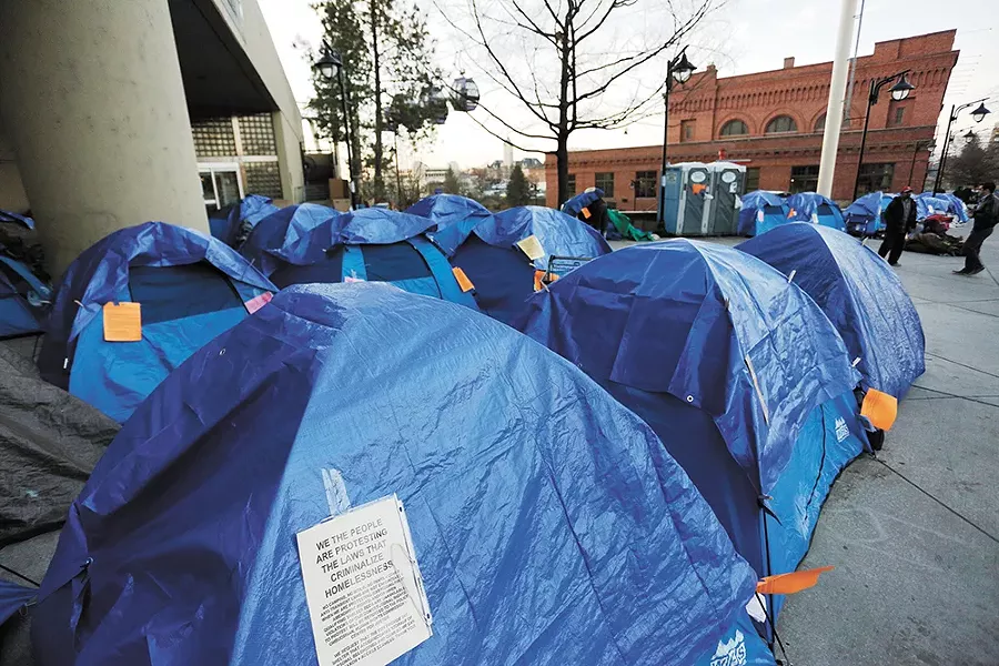 Weeks after city officials hoped new homeless shelters would be online, activists and homeless people erected a tent city outside City Hall. - YOUNG KWAK