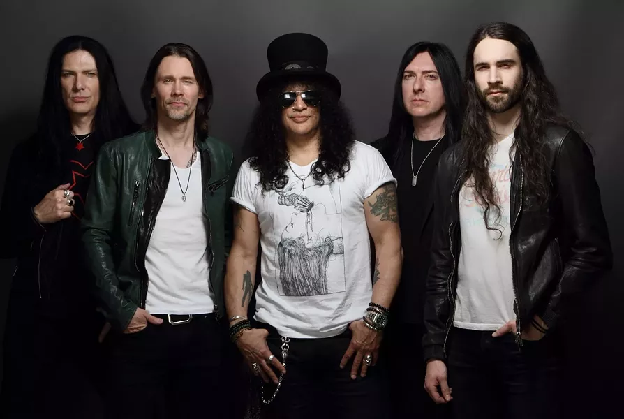 Slash (center) and Myles Kennedy (left center) and the Conspirators