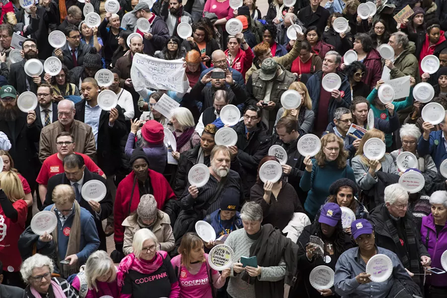 Demonstrators gather in the Hart Senate Office Building atrium to protest the government shutdown, in Washington, Jan. 23, 2019. With the shutdown now in its second month and 800,000 federal employees about to miss a second paycheck, pressure is rising on both parties to reopen the government. - SARAH SILBIGER/THE NEW YORK TIMES
