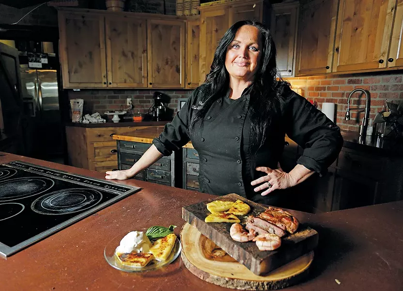 Chef Lesa Lebeau at the Culinary Stone with rib-eye steak, prawns and pineapple (served with vanilla ice cream), all grilled on a salt block. - YOUNG KWAK