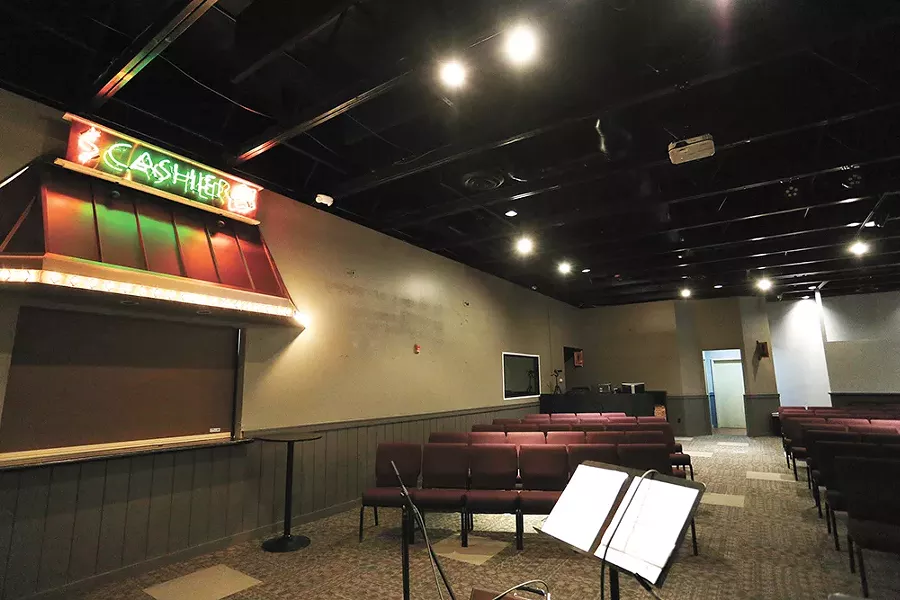 The interior of Uplift Church, with the cashier sign from its days as a Hooters. - YOUNG KWAK