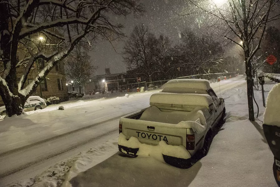 The Spokane snowpack Monday night buries a car on Riverside - DANIEL WALTERS PHOTO