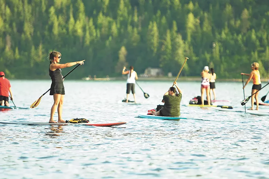 Kym Murdoch leads a class of paddle boarders on Lake Coeur d'Alene. - YOUNG KWAK
