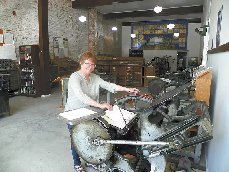 Palouse native Janet Barstow shows off the "fingersnapper," an antique printing press. - DAN NAILEN