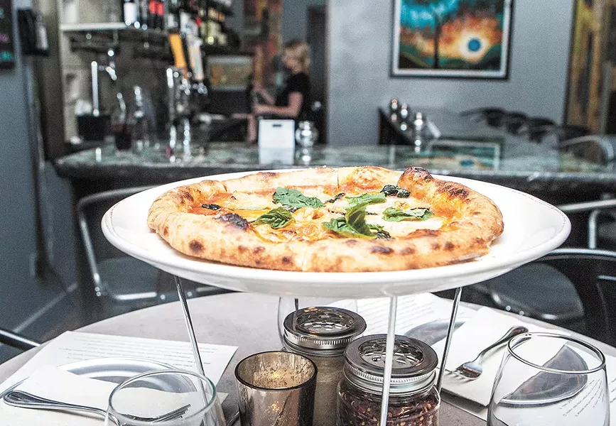 A freshly baked Margarita pizza at Piccolo Artisan Pizza Kitchen. - MEGHAN KIRK