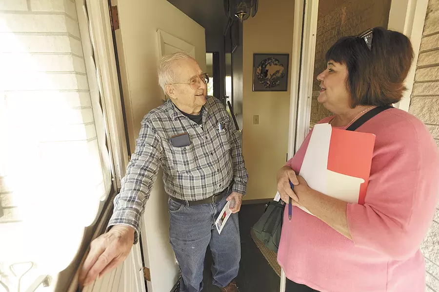 Karen Stratton speaks with voter Millard Lamb while door-belling. - YOUNG KWAK