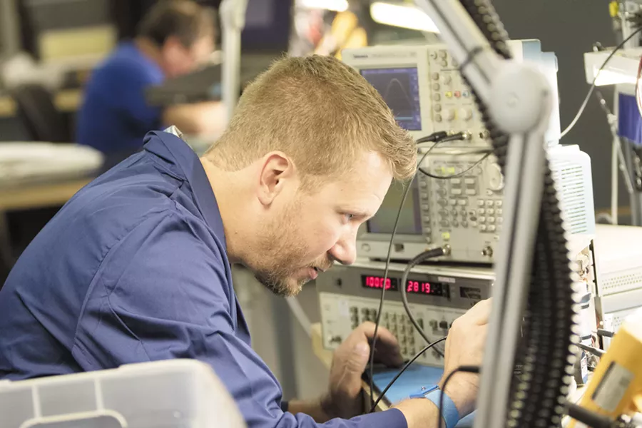 A repair technician uses a probe to test a PA amplifier from an MD-80 at Absolute Aviation Services. - YOUNG KWAK