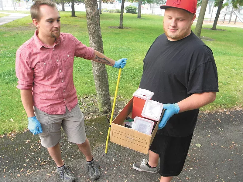 Ben Baird (left) and Shaw Jones help clean up the park. - JAKE THOMAS