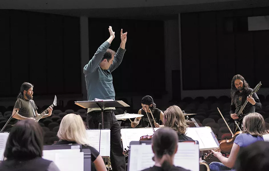 SFCC Chorale Director Nathan Lansing conducts the school's symphony orchestra in its collaboration with local band Age of Nefilim. - YOUNG KWAK