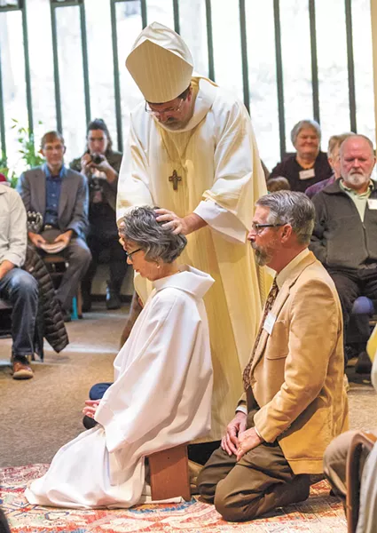 Linda Kobe-Smith, accompanied by her husband, Dan, is the first woman to be ordained as a priest in Spokane, and the second in the entire state. - JEFF FERGUSON