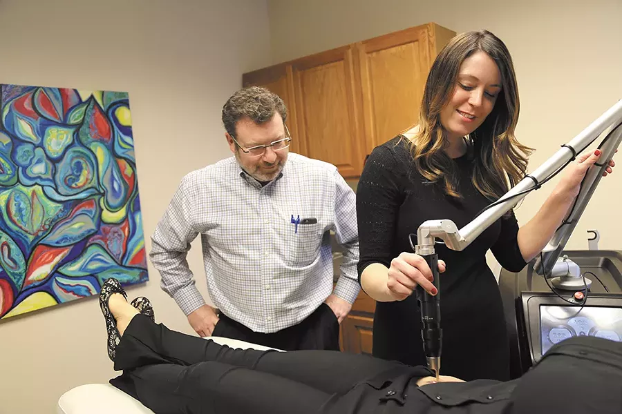 Dr. Kevin Johnson and aesthetic nurse Brittany Rayson use a laser for tattoo removal at Spokane's Advanced Aesthetics. - SARAH PHILIP