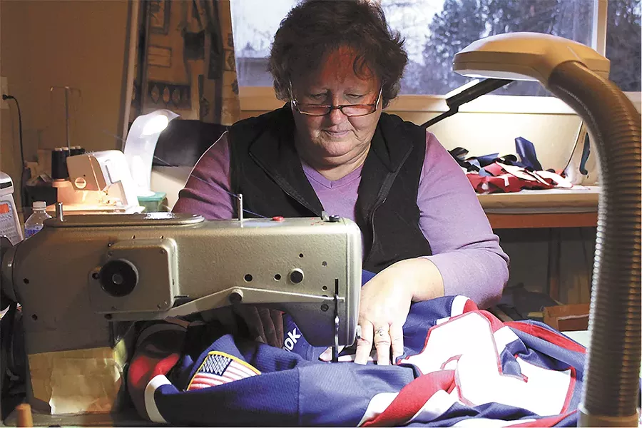 Barbara Parker sews a Spokane Chiefs jersey at her home studio. - QUINN WESTERN