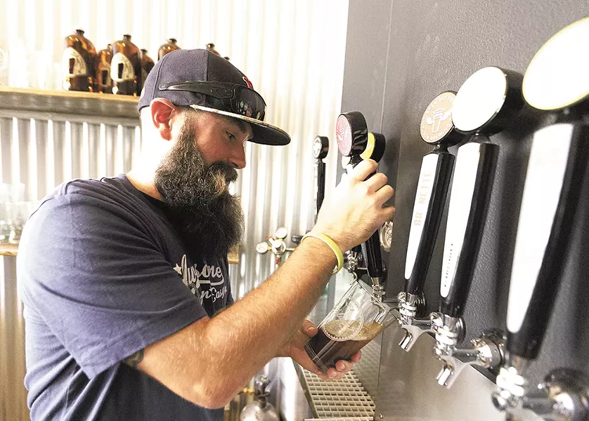 Markus Lowe pours a pint at Orlison's new taproom. - YOUNG KWAK