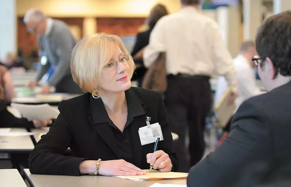 Mary Templeton interviews teaching candidates at a Spokane Public Schools hiring fair last week. - MIKE SALSBURY