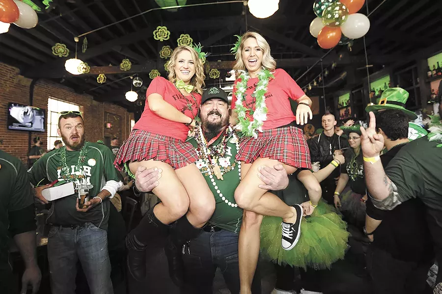 Patrick Andrews lifts up Caitlin Cooley (left) and Carey Smith. - YOUNG KWAK