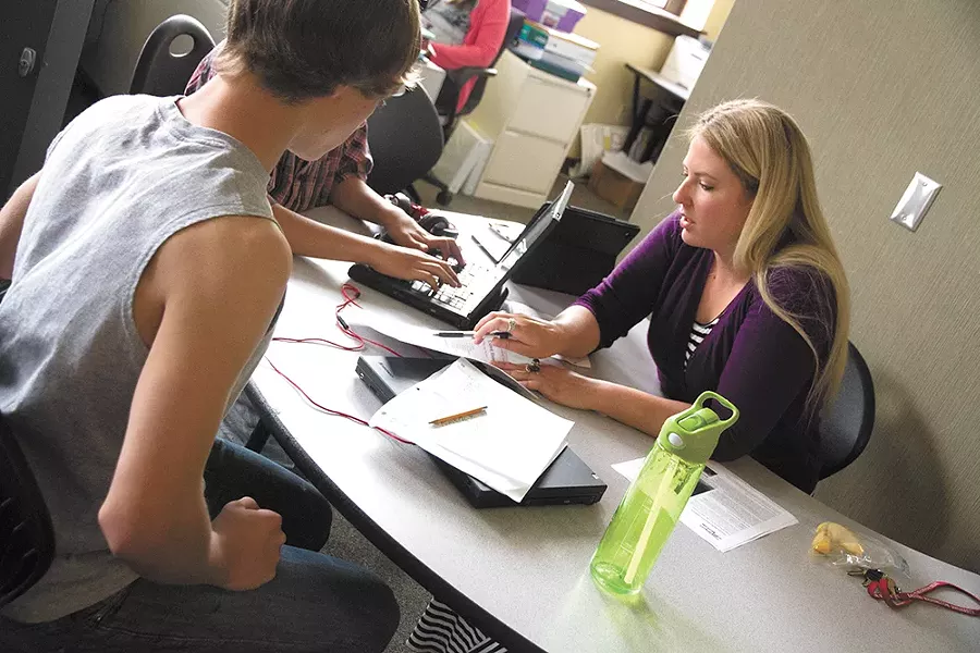 Stephanie Robinette, a special education teacher at Rogers High School, helps students. - JENNIFER DEBARROS