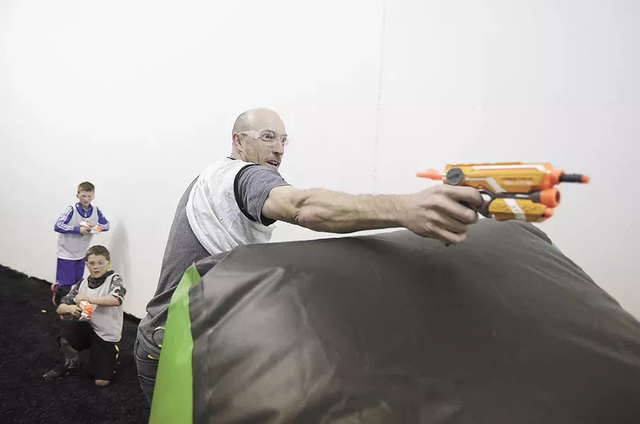 Brian Meier shoots a Nerf gun at Xtreme Arena, where adults can get in on the fun. - YOUNG KWAK