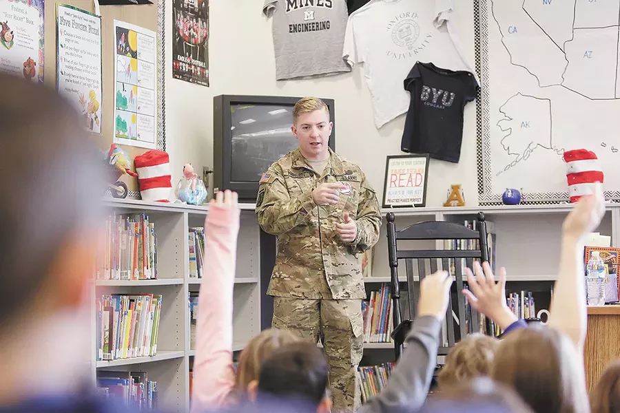 Army Spc. Chris Hansen, stationed at Fort Drum, N.Y., visits a first-grade class at Adams Elementary School, where he was once a student. - YOUNG KWAK