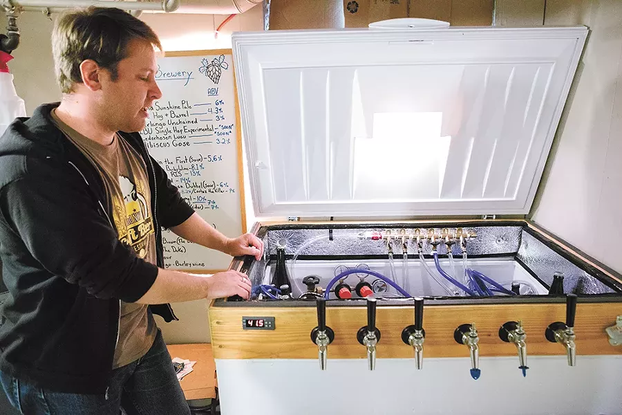 Adam Boyd examines the tap system. - KRISTEN BLACK