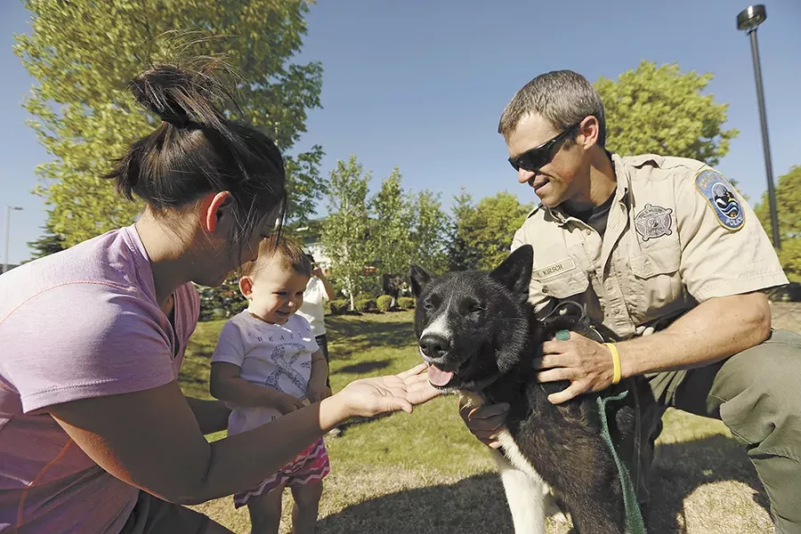 Karelian bear dog Jax meets the public with his handler, Officer Keith Kirsch. - YOUNG KWAK