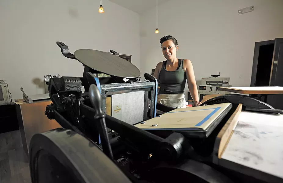 Breanna White with her main press, a 1926 machine she restored to working condition two years ago. - YOUNG KWAK