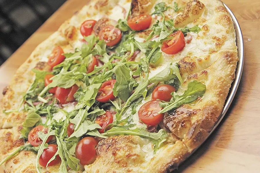 South Perry’s prosciuto pizza is finished with fresh arugula and cherry tomatoes. - YOUNG KWAK