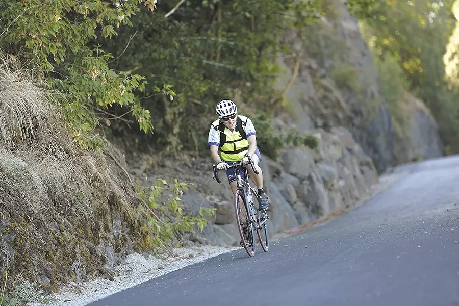 Cyclist Martha Jones glides over the freshly paved section of the Ben Burr Trail near South Altamont Street. - YOUNG KWAK