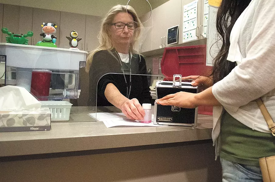 A nurse at the Spokane Regional Health District dispenses methadone to a patient. | SARAH PHILP photo