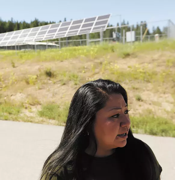 Maria Cullooyah, planning manager for the Spokane Tribe, is helping the tribe move toward renewable energy, like the community solar array behind her. - YOUNG KWAK