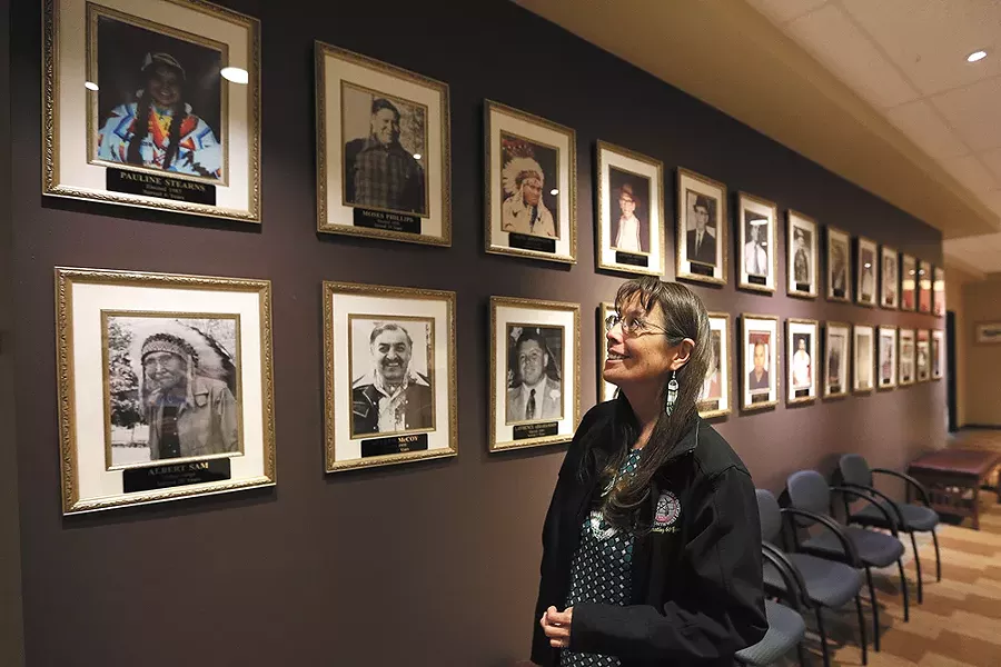 Carol Evans, tribal chairwoman, looks up at a picture of her mother, Pauline Stearns, the first woman to serve on the tribal council. - YOUNG KWAK