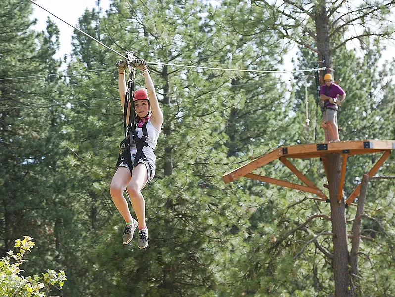 Mallory Johnson zips down the line at Mica Moon Zip Tours near Liberty Lake. - TIMOTHY PHILLIPS