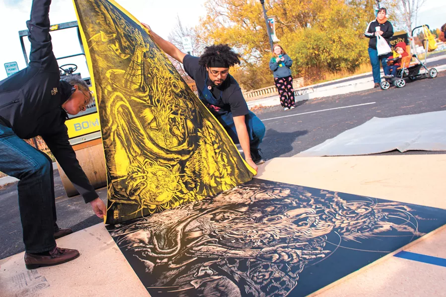 Reinaldo Gil Zambrano, left, an art instructor, created prints using a steamroller last fall. - JOSEPH PALLEN/UNIVERSITY OF IDAHO