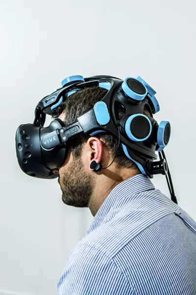 Michael Thompson, vice president of business development at Neurable, wears a headset that is part of the prototype for a game that lets users control actions with their thoughts, in San Francisco, July 7, 2017. The prototype is among the earliest fruits of a widespread effort to embrace technology that was once science fiction — and in some ways still is. - CHRISTIE HEM KLOK/THE NEW YORK TIMES