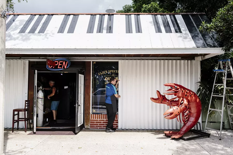 Mark Kren closes the storm shutters at Crawdaddy's, his restaurant in Jensen Beach, Fla., Sept. 8, 2017. Gov. Rick Scott of Florida said Hurricane Irma would be “way bigger than Andrew,” warning hundreds of thousands of people in its path to flee. - JASON HENRY/THE NEW YORK TIMES