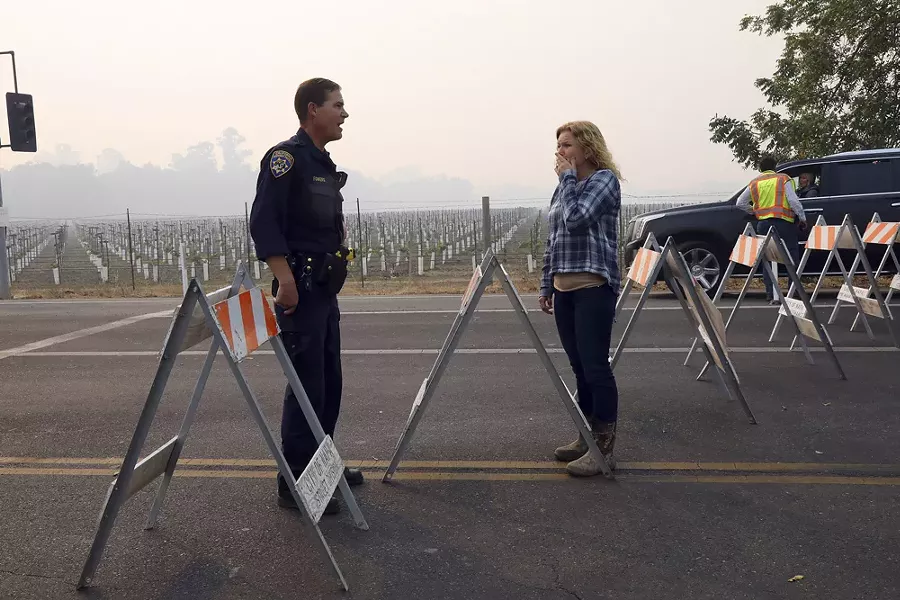 A woman pleads with a California Highway Patrol officer to allow her through a roadblock to an area damaged by wildfires in Napa, Calif., Oct. 10, 2017. - JIM WILSON/THE NEW YORK TIMES