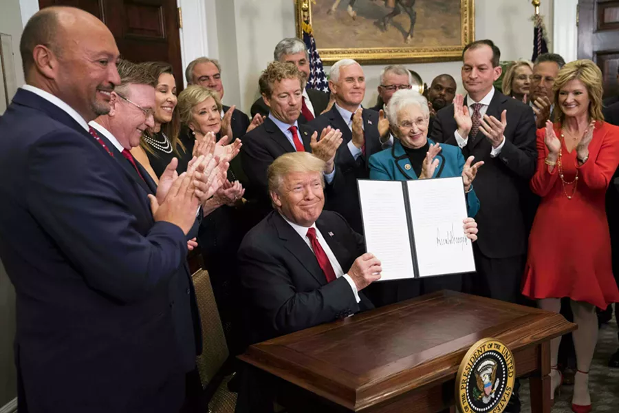 President Donald Trump signs an executive order that clears the way for potentially sweeping changes in health insurance, during an event attended by small-business owners and others at the White House, in Washington, Oct. 12, 2017. - DOUG MILLS/THE NEW YORK TIMES