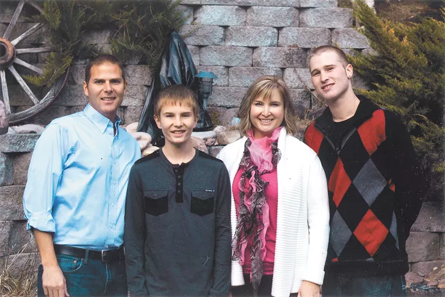 Tyler (right) with his mom, half brother and stepfather on Thanksgiving 2014.