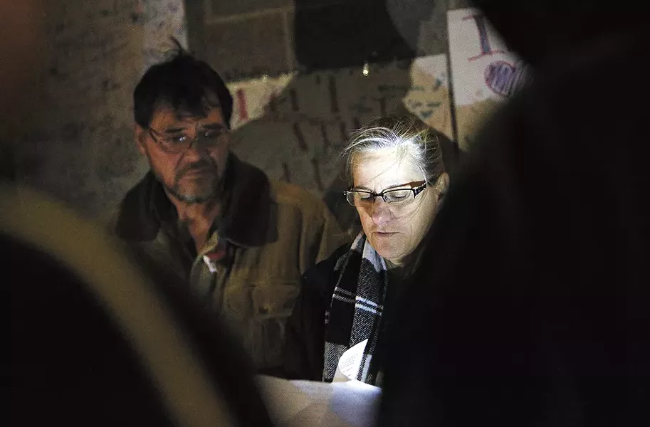 Donna Fagan, pictured in front of her husband, City Councilman Mike Fagan, organized a candlelight vigil on Sunday to pray for those who are lost to their circumstances. - YOUNG KWAK