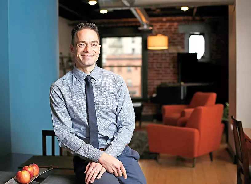 Tim Westerhaus enjoys observing the - busy streetscape from his soundproofed, third-floor condo on First Avenue. - YOUNG KWAK