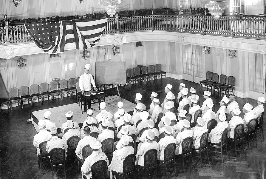 Chef Mathieu speaks to the Davenport's culinary team in this 1922 photo. - DAVENPORT HOTELS PHOTO