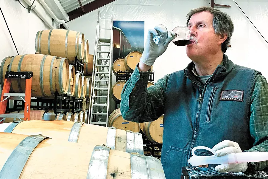 Phillip Butterfield tastes and tests Winescape's malbec barrels. - PATRICIA BUTTERFIELD PHOTO