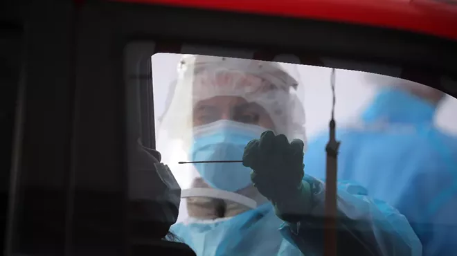 A driver is tested for coronavirus infection at a site in Oakland, Calif., Nov. 19, 2020. People with Covid-19, the illness caused by the coronavirus, are most infectious about two days before symptoms begin and for five days afterward, according to a new analysis of previous research.